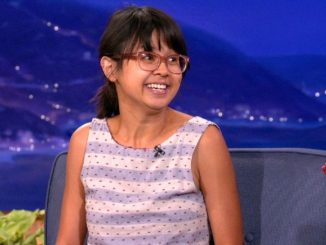 Charlyne Yi in a purple-white top at an interview.