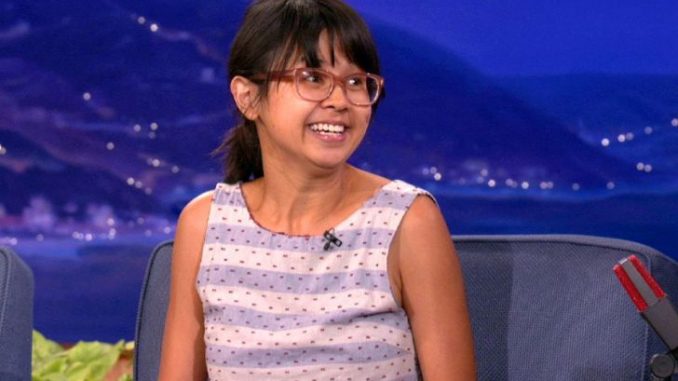 Charlyne Yi in a purple-white top at an interview.
