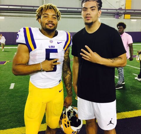 Thaddeus Moss in the jersey of LSU Tigers with a friend.