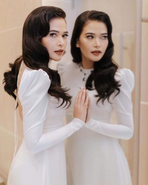 Bela Padilla giving a pose while wearing a white dress.