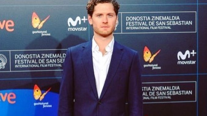 Kyle Soller in a dark blue suit at an event.