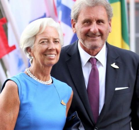 Xavier Giocanti in black suit with girlfriend Christine Lagarde in blue dress.