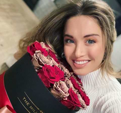 Melissa Bolona clicks a selfie with roses.