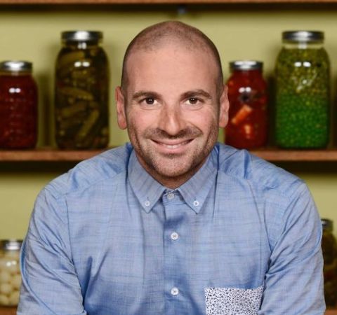 George Calombaris in a blue shirt poses for a photo.