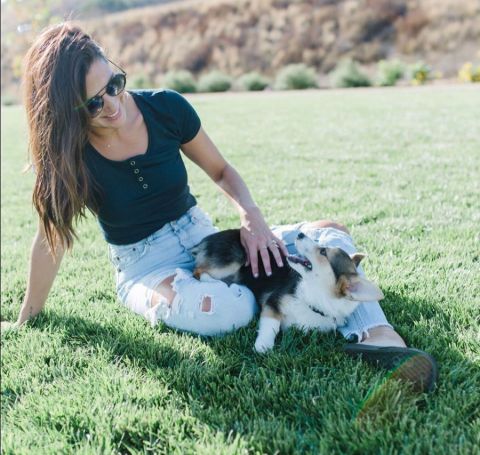Becca Kufrin with  her pet dog poses for a photo. 
