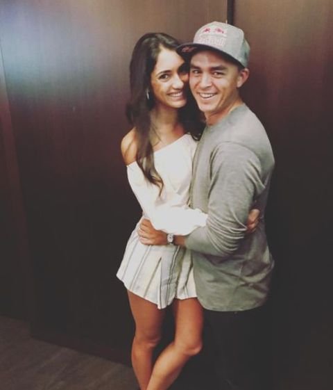 Allison Stokke giving a pose along with her husband, Rickie Fowler.