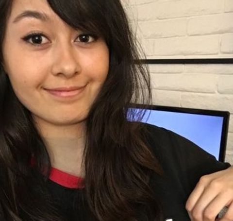 Jaiden Animations in a black t-shirt smiles at the camera.