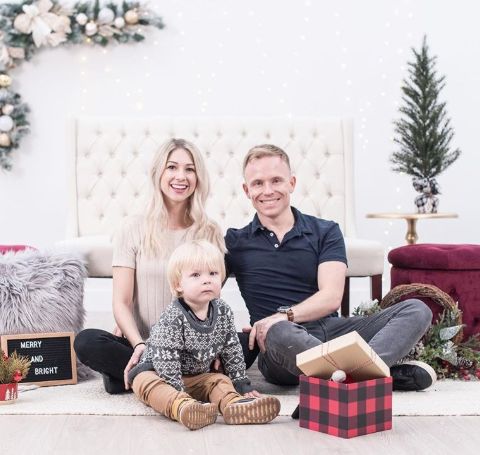 Adrian Petriw in black t-shirt poses for a X-mas photo with wife Paige and son.