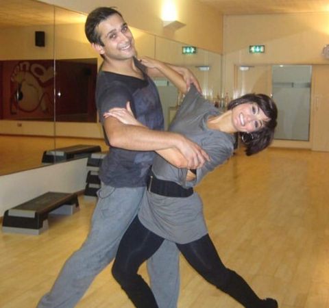 Jimi Mistry in a black t-shirt dancing with wife Flavia Cacace.
