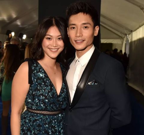 Manny Jacinto in a black suit poses with soon to be bride Dianne Donn.