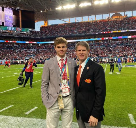 Knobel Hunt in a grey suit with Clark Hunt in a black suit.