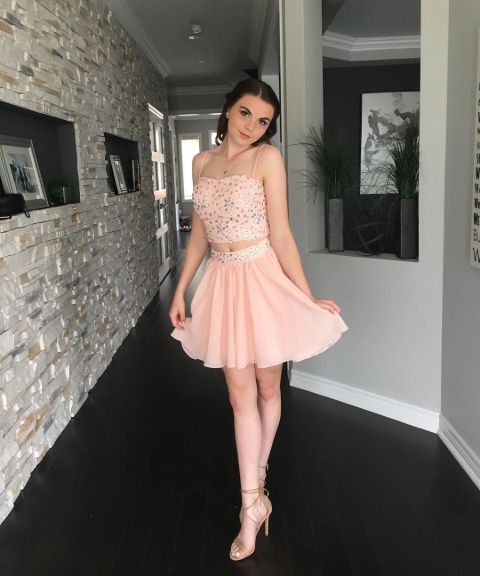 Avery Trask in a pink dress poses for a picture.