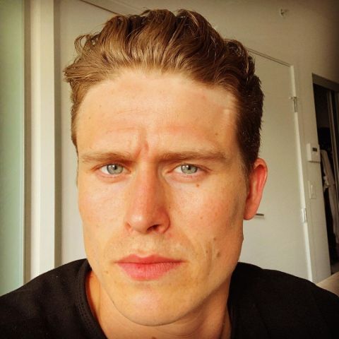 RJ Fetherstonhaugh in a black t-shirt poses for a selfie.