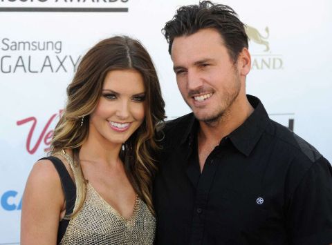 Audrina Patridge in a grey dress poses a picture with ex-husband Corey Bohan.