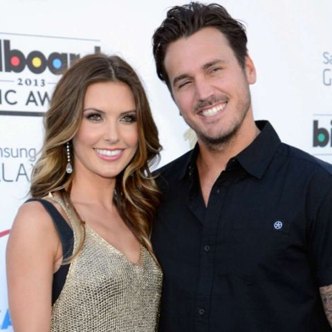 Corey Bohan in a black t-shirt poses a picture with her ex-wife Audrina Patridge.