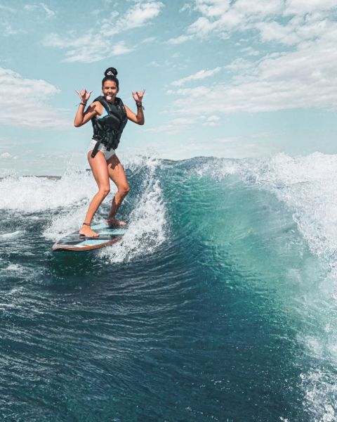 Klailea Bennett surfing on the sea.