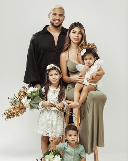 Luis Espina poses for a picture with his wife Bramty Juliette with their children.