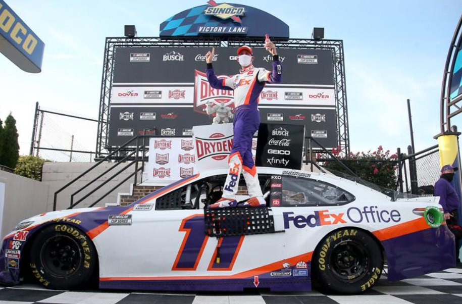 Denny Hamlin celebrates in Victory Lane after winning the NASCAR Cup Series Drydene 311 Dover