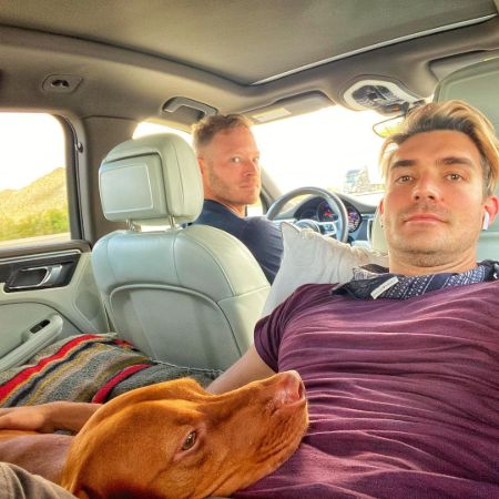 Jacob Jules Villere with his Husband with their dog in their car