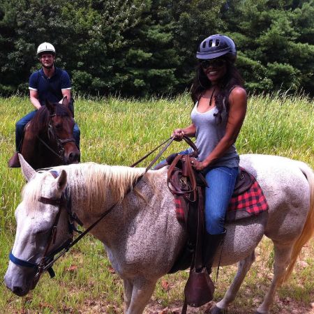Bradford Sharp and his wife riding horse on a vacation