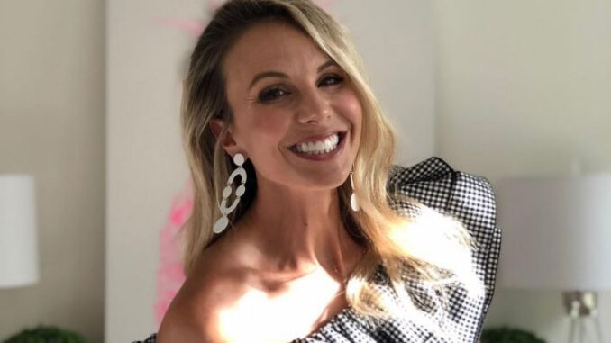 Elisabeth Hasselbeck wearing a pretty black and white dress and smiling.