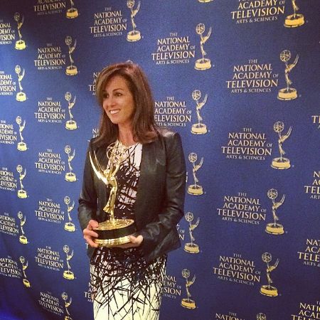  Janet Shamlian posing for a photo with her award.

