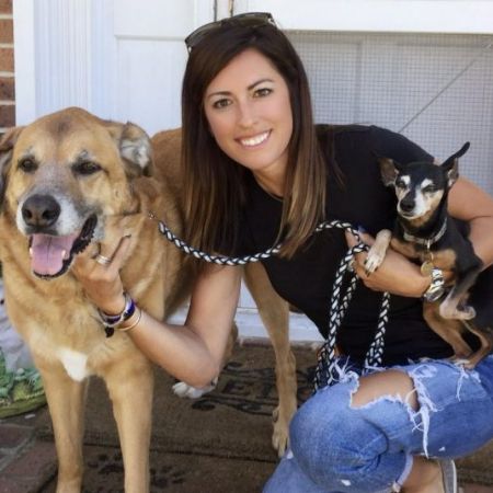 Renee Satterthwaite posing with her dogs.