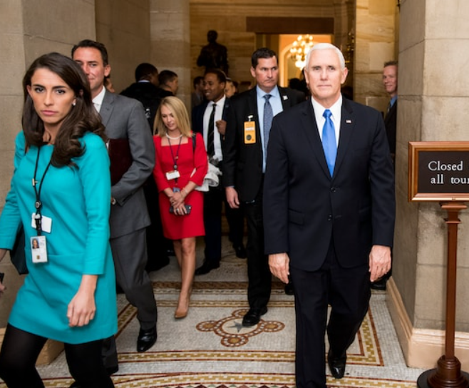 Alyssa Farah (left) walking alongside Vice President Mike Pence (right)