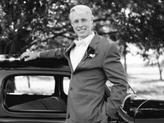 Ethan Plath wearing a tux and smiling for a photo.