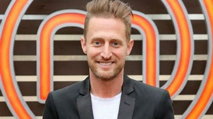 Michael Voltaggio dressed up and smiling for a photo.