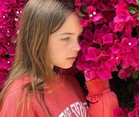 Ryan Kiera Armstrong posing with the flowers.